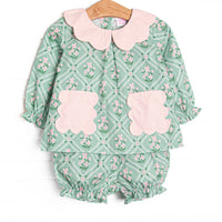 This set features a tile and floral print, a pink scalloped collar, and pink scalloped front pockets. Coordinating bloomer shorts to match.