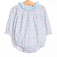  This bubble features a blue floral print, blue ruffle collar, and snaps on the stride to make changing a breeze. 