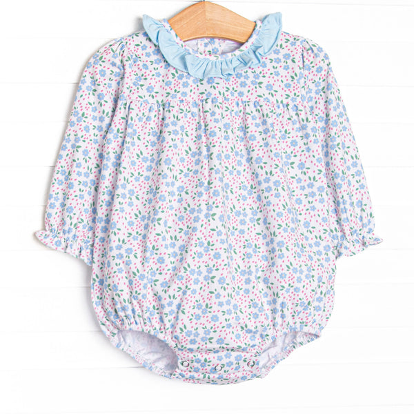  This bubble features a blue floral print, blue ruffle collar, and snaps on the stride to make changing a breeze. 
