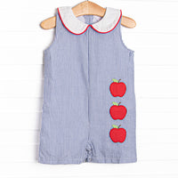 This Jon Jon features navy seersucker fabric, a peter pan collar with red pipping, and apple trio applique.