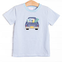  This top features a blue striped print,, pickup truck applique, and blue trim. 