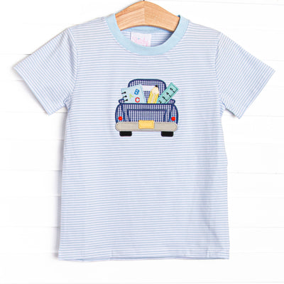  This top features a blue striped print,, pickup truck applique, and blue trim. 