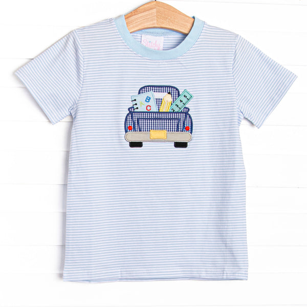  This top features a blue striped print,, pickup truck applique, and blue trim. 
