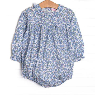  This bubble features a blue floral print, snaps on the stride, and ruffles collar. 