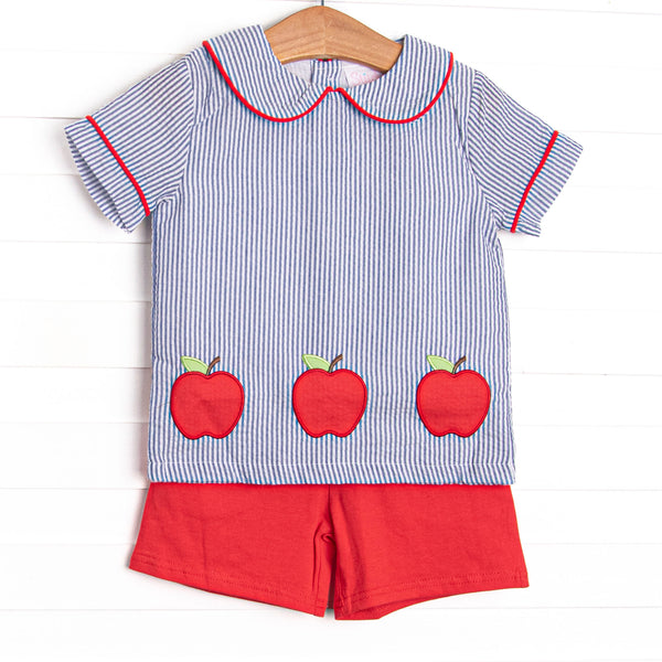 This set features navy seersucker top with a peter pan collar, and&nbsp; apple trio applique. Coordinating red shorts to match.