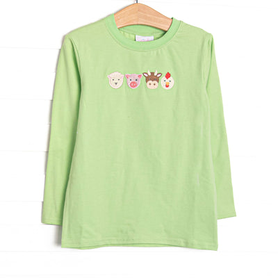  This top features light green fabric, long sleeves, and farm animal embroideries. 