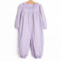  This romper features a purple windowpane print, a ruffle collar, and snaps on the stride. 