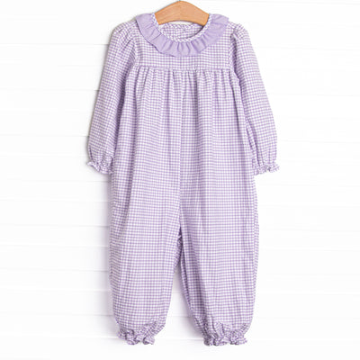  This romper features a purple windowpane print, a ruffle collar, and snaps on the stride. 
