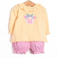 This set features a yellow top, a piglet applique, and a yellow ruffle collar. Coordinating pink gingham bloomer shorts to match.