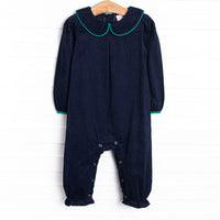  This romper features a blue corduroy material, a peter pan collar, and green trim. 