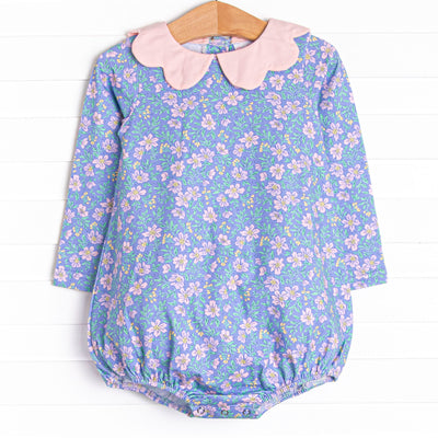  This bubble features a purple floral print, a pink scalloped collar, and the softest knit material. 