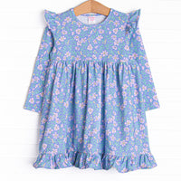 This dress features a purple floral print, ruffle trim, and the softest knit material.