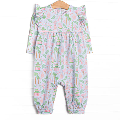  This romper features a mahjong inspired print, ruffle trim, and snaps on the stride. 
