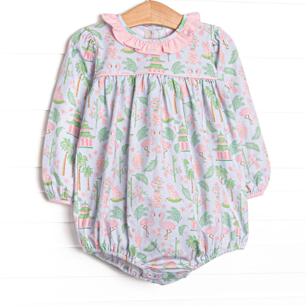  This bubble features a mahjong inspired print, pink ruffle collar, and snaps on the stride. 