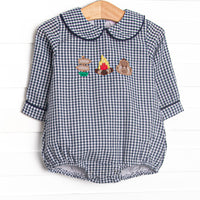  This bubble features a navy blue gingham print, a peter pan collar, and a camp inspired applique. 