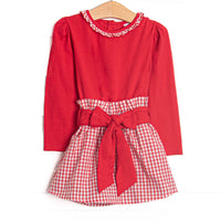  This set features a red top, a windowpane ruffle collar, and a windowpane skirt with a red waist tie. 