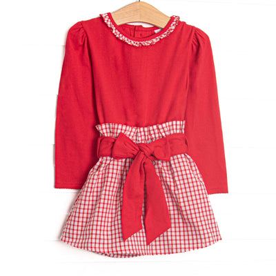  This set features a red top, a windowpane ruffle collar, and a windowpane skirt with a red waist tie. 
