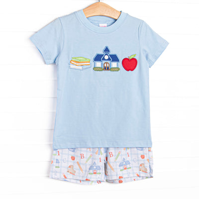  This set features a blue shirt with school appliques including books, a schoolhouse, and an apple. Coordinating patterned shorts to match. 