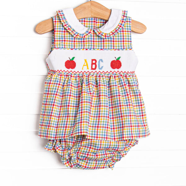 This set features a multicolored plaid fabric, a Peter Pan plaid trimmed collar, and ABC and apple smocking. Coordinating diaper cover to match.