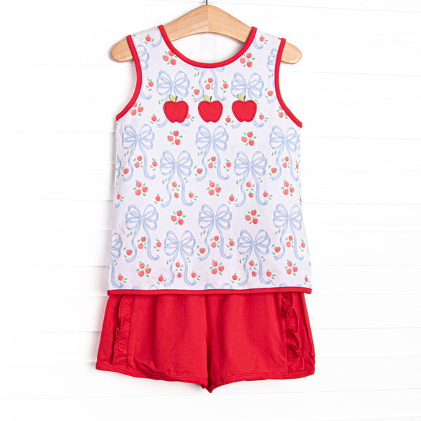 This set features A white blue bow and apple patterned tank, a criss-cross back, and red piping trim.