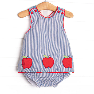 his set features a navy seersucker fabric, red fabric covered buttons, apple trio applique, red piping trim, and a criss-cross back. Coordinating diaper cover to match. 