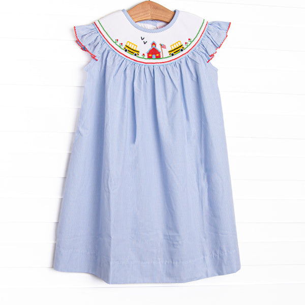 This dress features a blue striped material, schoolhouse smocking, flutter sleeves, and red picot trim.