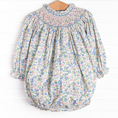  This bubble&nbsp; features a pink floral print, snaps on the stride, and the sweetest smocking. 