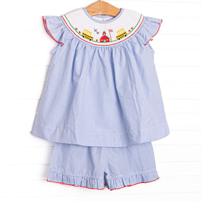 This set features a blue striped material, schoolhouse smocking, and flutter sleeves.