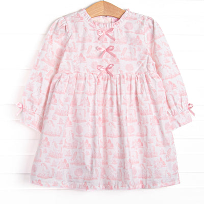This dress features a pink dainty unicorn print, a trio of pink satin bows, and ruffle trim
