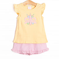 This set features a&nbsp; yellow flutter sleeve top with a colored pencils and bow applique. Coordinating pink seersucker shorts to match.