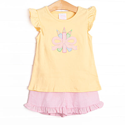 This set features a&nbsp; yellow flutter sleeve top with a colored pencils and bow applique. Coordinating pink seersucker shorts to match.