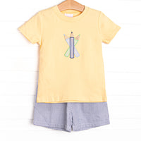 This set features a&nbsp; yellow short sleeve top with a colored pencils&nbsp; applique. Coordinating navy seersucker shorts to match.