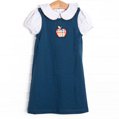 This set features a navy blue dress with a plaid apple applique and a puff sleeve top with a peter pan collar for layering.