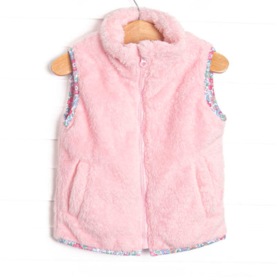 This vest features the softest pink fuzzy fleece, pockets to keep little hands warm, and a full zipper down the front.