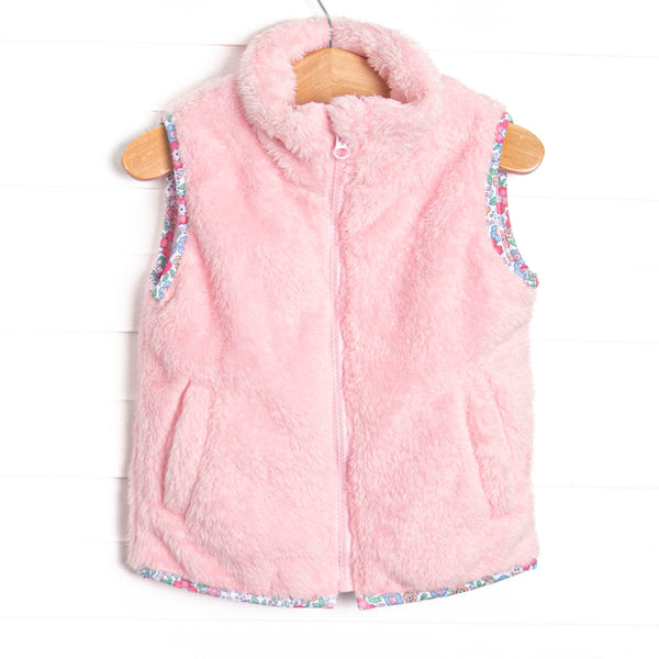 This vest features the softest pink fuzzy fleece, pockets to keep little hands warm, and a full zipper down the front.