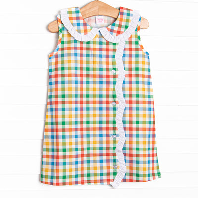 This dress features a plaid print, a peter pan collar, and white ruffle trim.