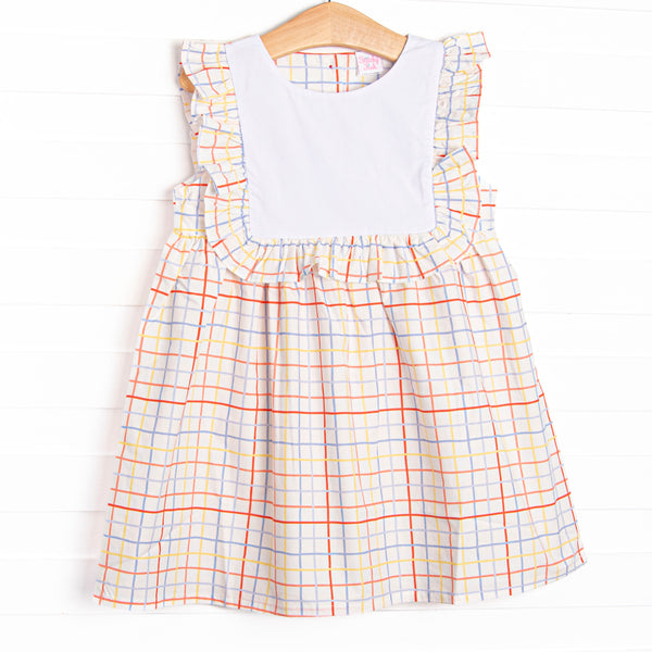  This dress features a plaid print, a bib collar, and ruffle trim. 