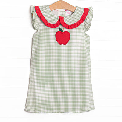 This dress features a green gingham print, peter pan collar with red ruffle trim, and apple applique.