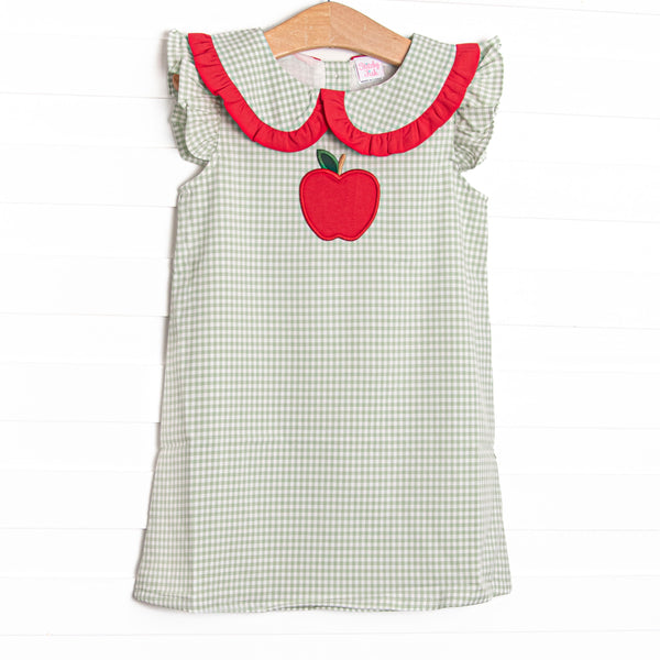 This dress features a green gingham print, peter pan collar with red ruffle trim, and apple applique.