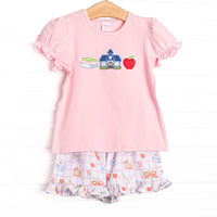  This set features a pink puff sleeve shirt with school appliques including books, a schoolhouse, and an apple. Coordinating school patterned ruffle shorts to match. 