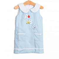 A sweet applique featured in blue bitty dot that is perfect for back to school! This woven dress will be a favorite for your little girl. Peter pan collar, button down back, and an ABC applique
