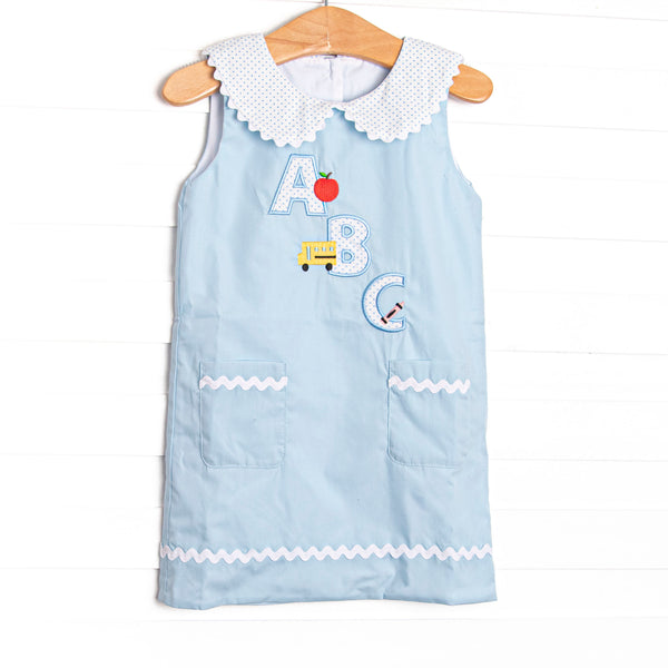 A sweet applique featured in blue bitty dot that is perfect for back to school! This woven dress will be a favorite for your little girl. Peter pan collar, button down back, and an ABC applique