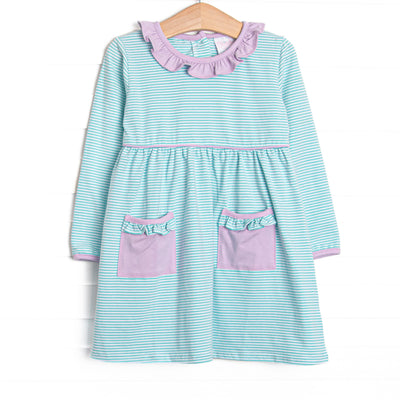  This dress features mint green stripes, front pockets, and ruffle trim. 