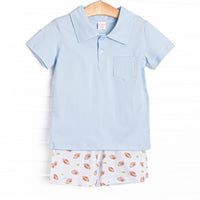 This set features a blue polo top and football print shorts to match.