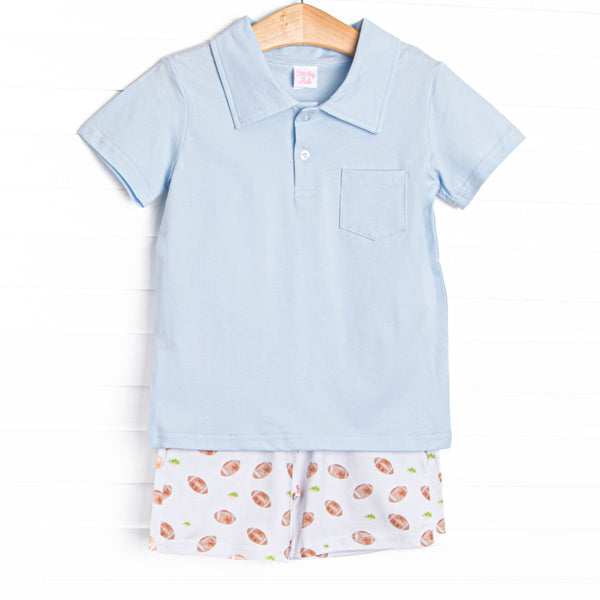 This set features a blue polo top and football print shorts to match.