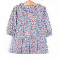 This dress features a purple floral print, a ruffle collar ,and a trio of bows appliques.