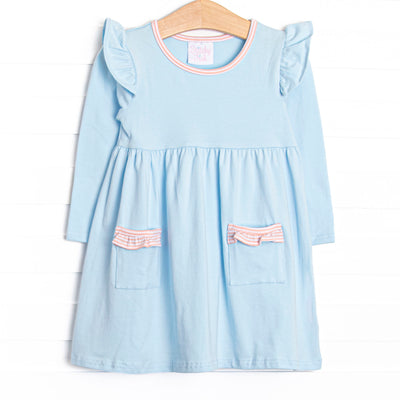 The dress features front ruffle pockets, peach striped trim, and the softest blue knit material. 