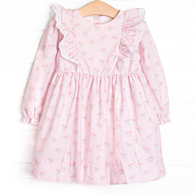 This dress features a rose print, ruffle shoulder details, and eyelet lace.