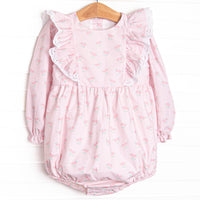  This bubble&nbsp;features a rose print, ruffle shoulder details, and eyelet lace. 