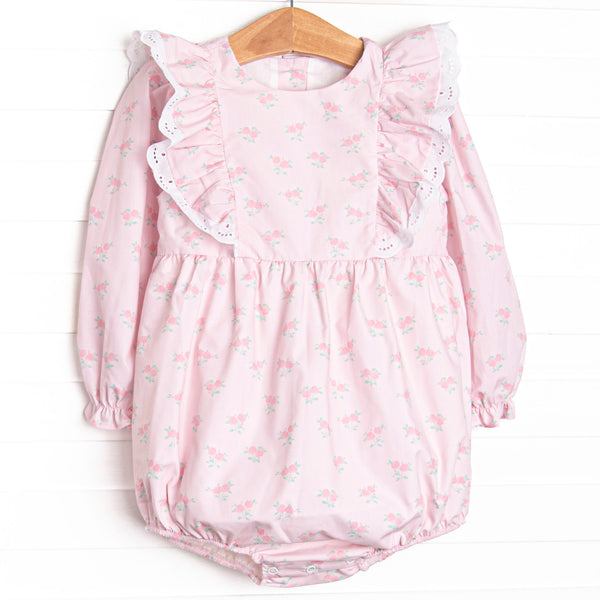  This bubble&nbsp;features a rose print, ruffle shoulder details, and eyelet lace. 